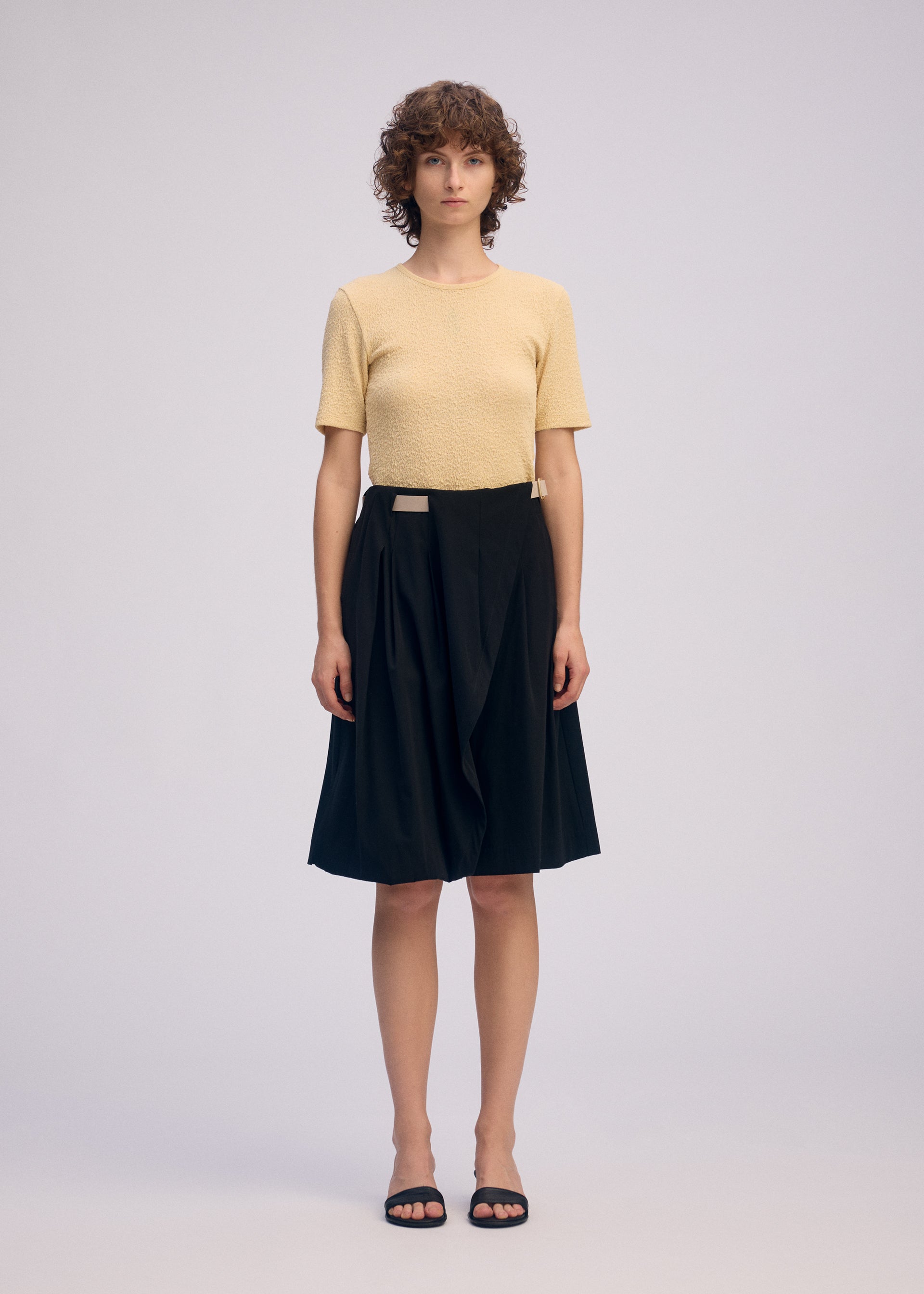 A model wears the ISSEY MIYAKE LOOPED trousers.