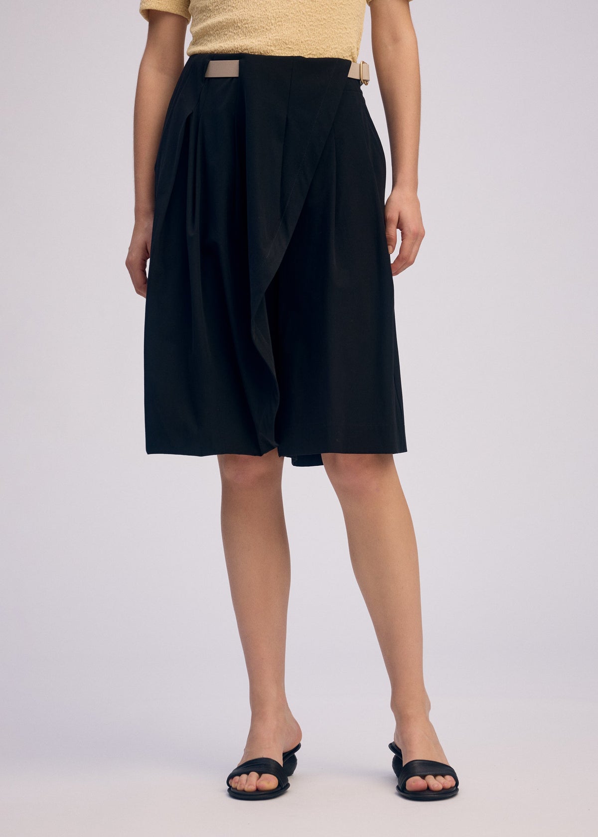A model wears the ISSEY MIYAKE LOOPED trousers.