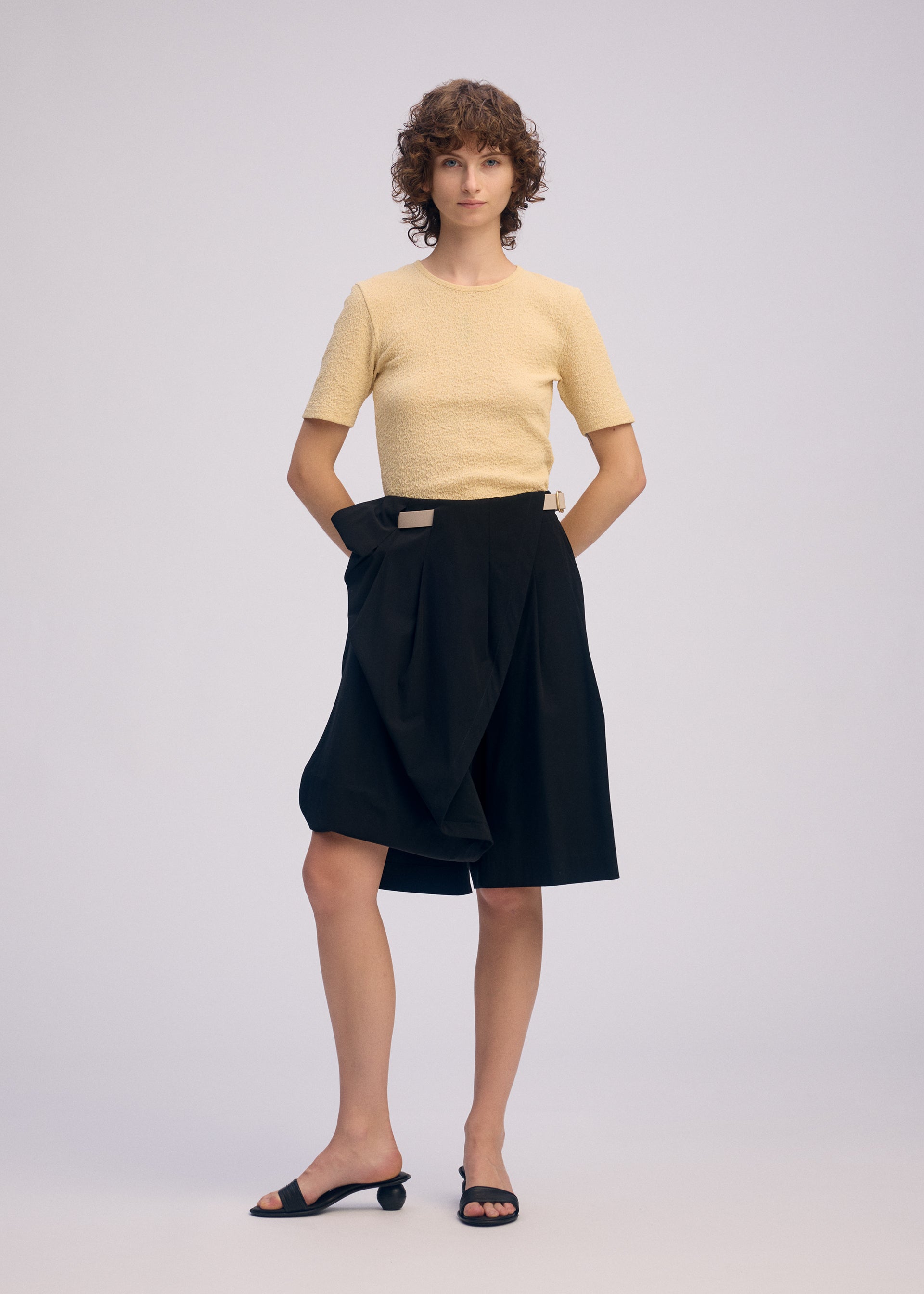 A model wears the ISSEY MIYAKE LOOPED trousers.