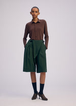 A model wears the ISSEY MIYAKE LOOPED trousers.