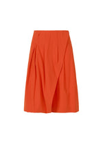 A product shot of the ISSEY MIYAKE LOOPED trousers in macaw red (28).