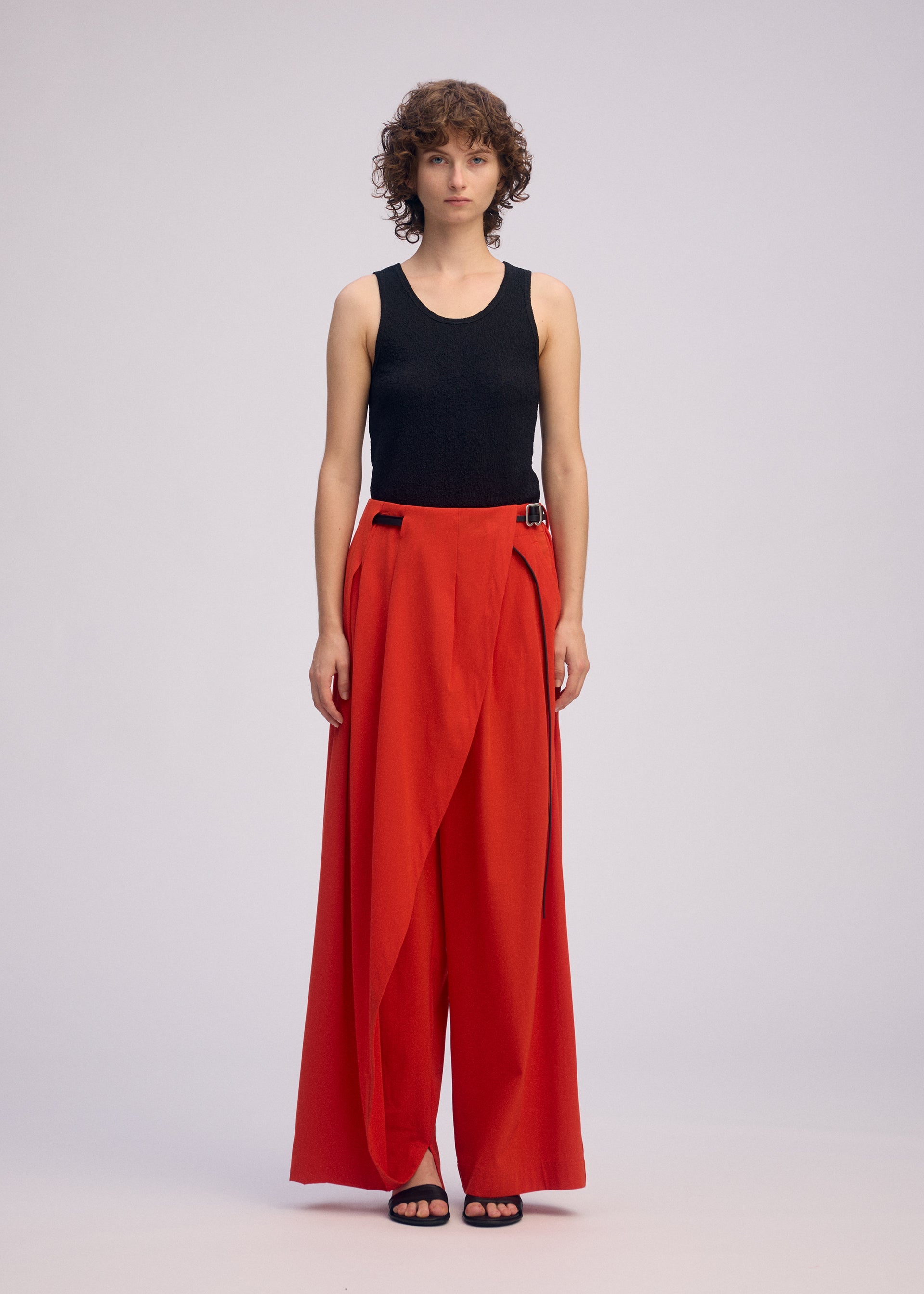 A model wears the ISSEY MIYAKE LOOPED trousers.