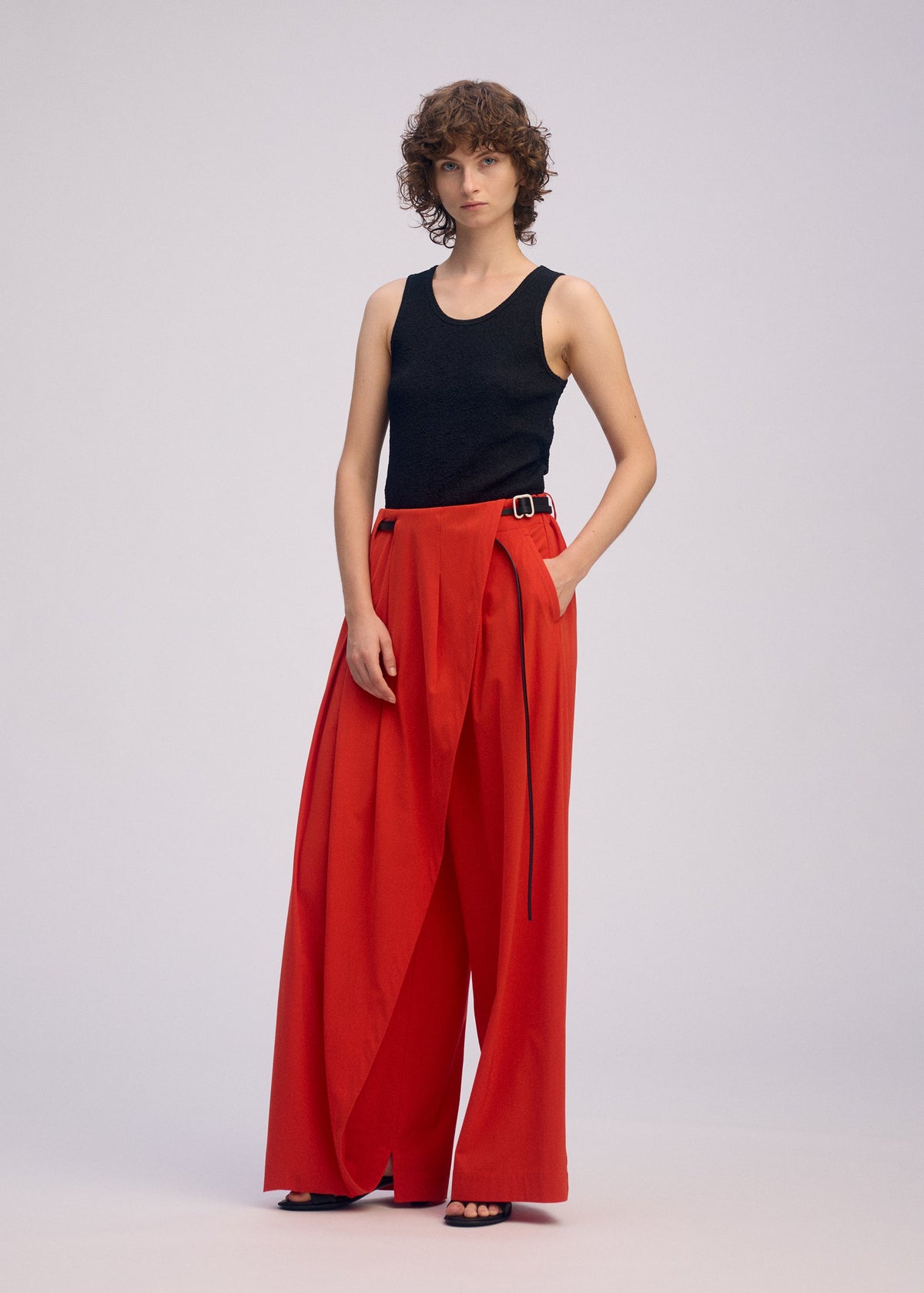 A model wears the ISSEY MIYAKE LOOPED trousers.
