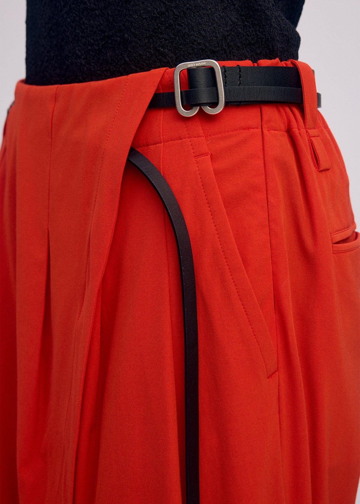 A model wears the ISSEY MIYAKE LOOPED trousers.