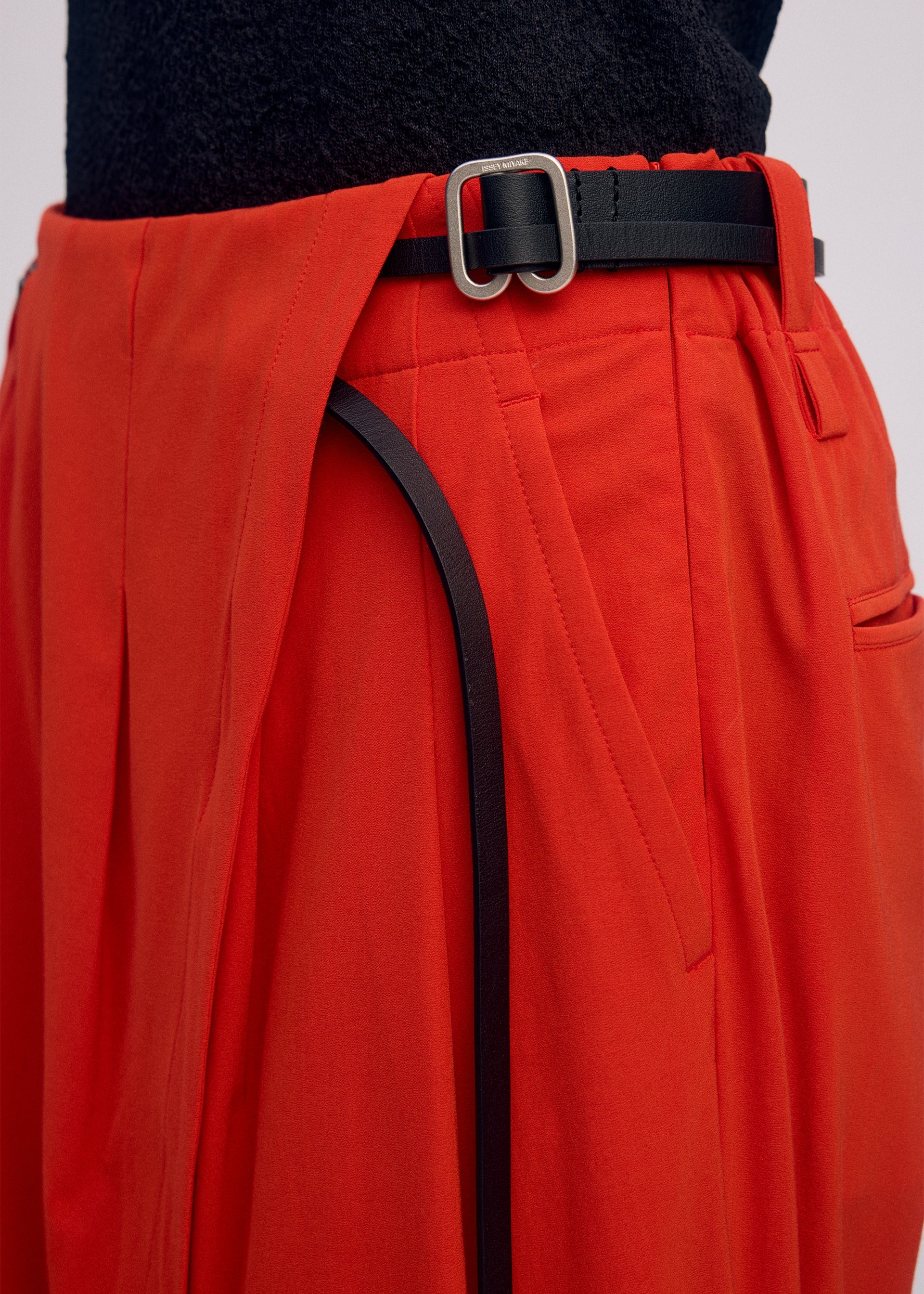 A model wears the ISSEY MIYAKE LOOPED trousers.