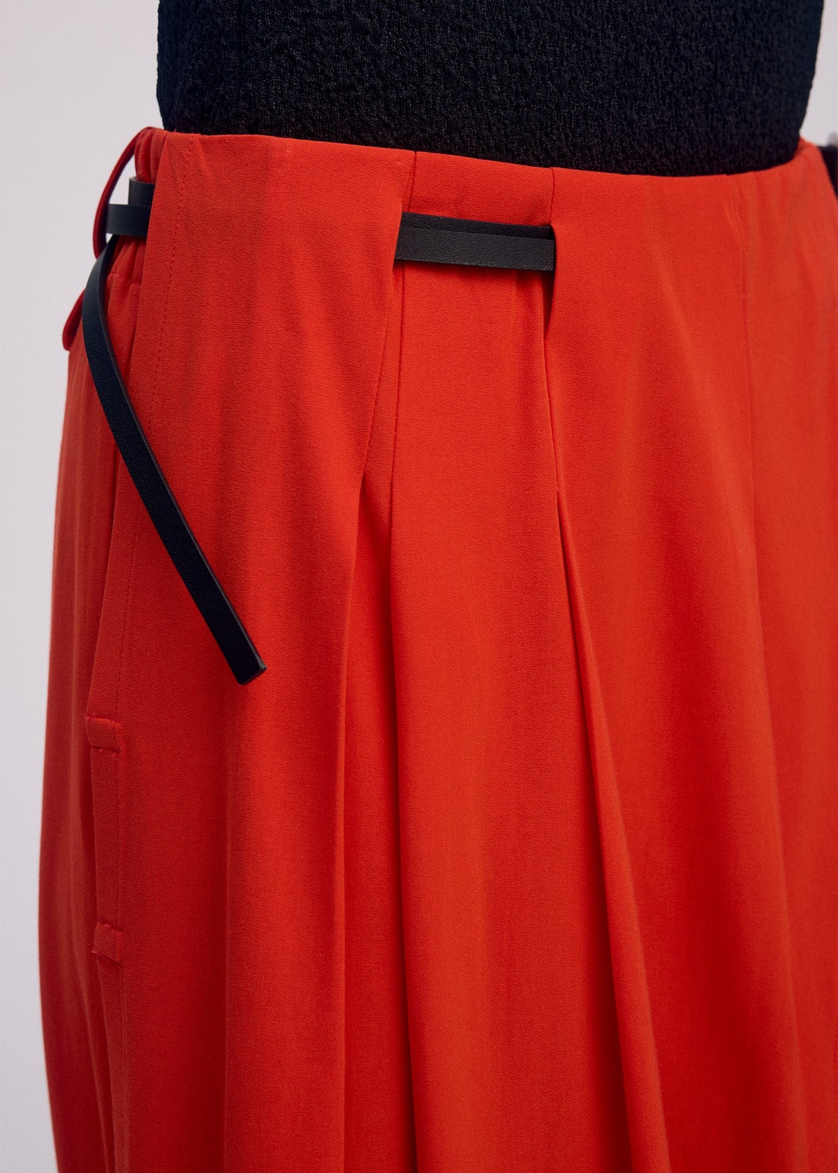 A model wears the ISSEY MIYAKE LOOPED trousers.