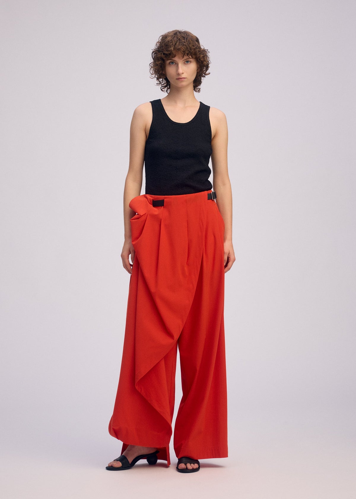 A model wears the ISSEY MIYAKE LOOPED trousers.