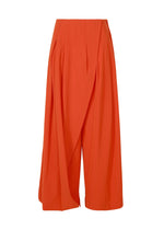 A product shot of the ISSEY MIYAKE LOOPED trousers in macaw red (28).