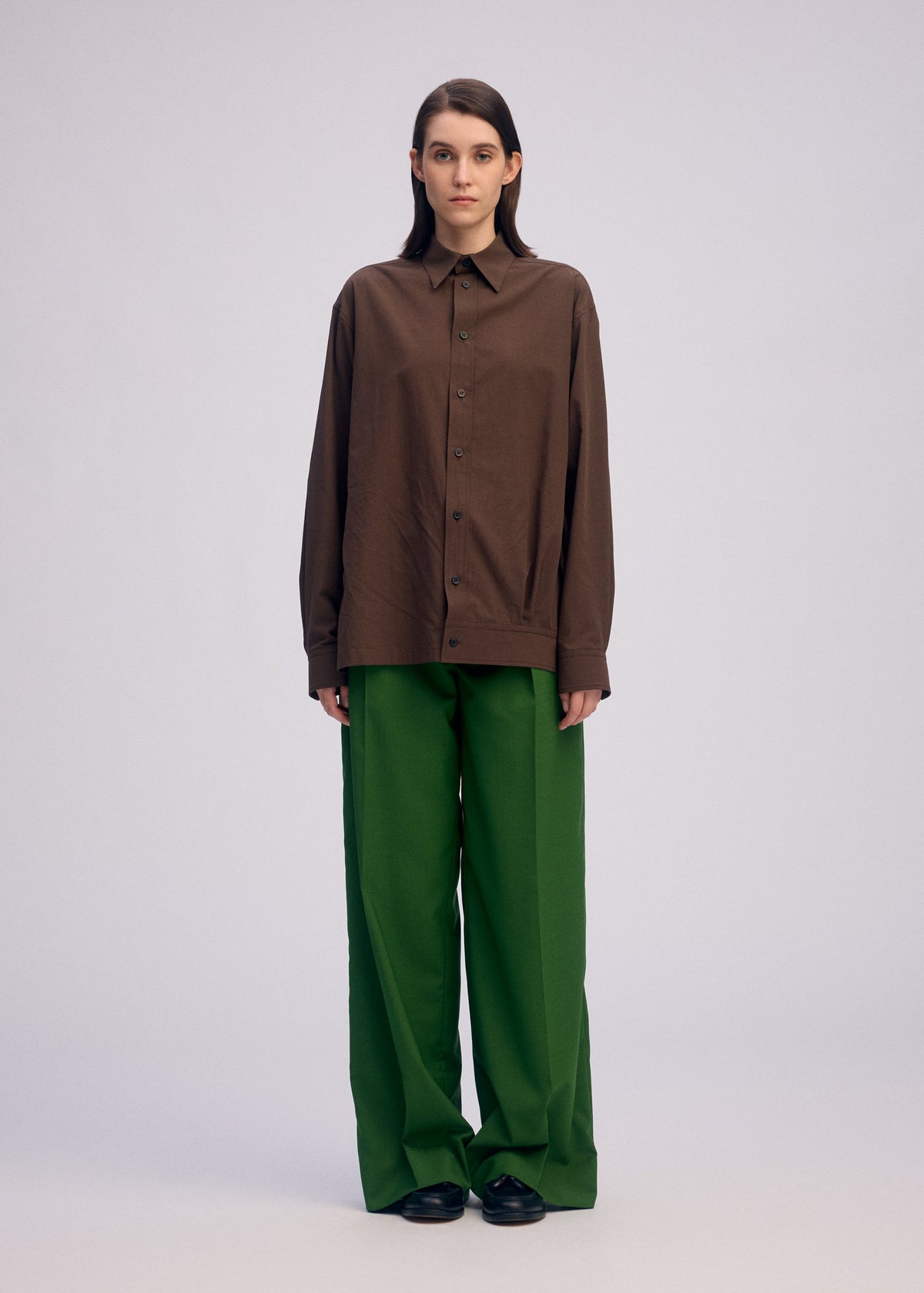 A model wears the ISSEY MIYAKE PALINDROME trousers.
