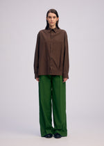 A model wears the ISSEY MIYAKE PALINDROME trousers.