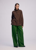 A model wears the ISSEY MIYAKE PALINDROME trousers.