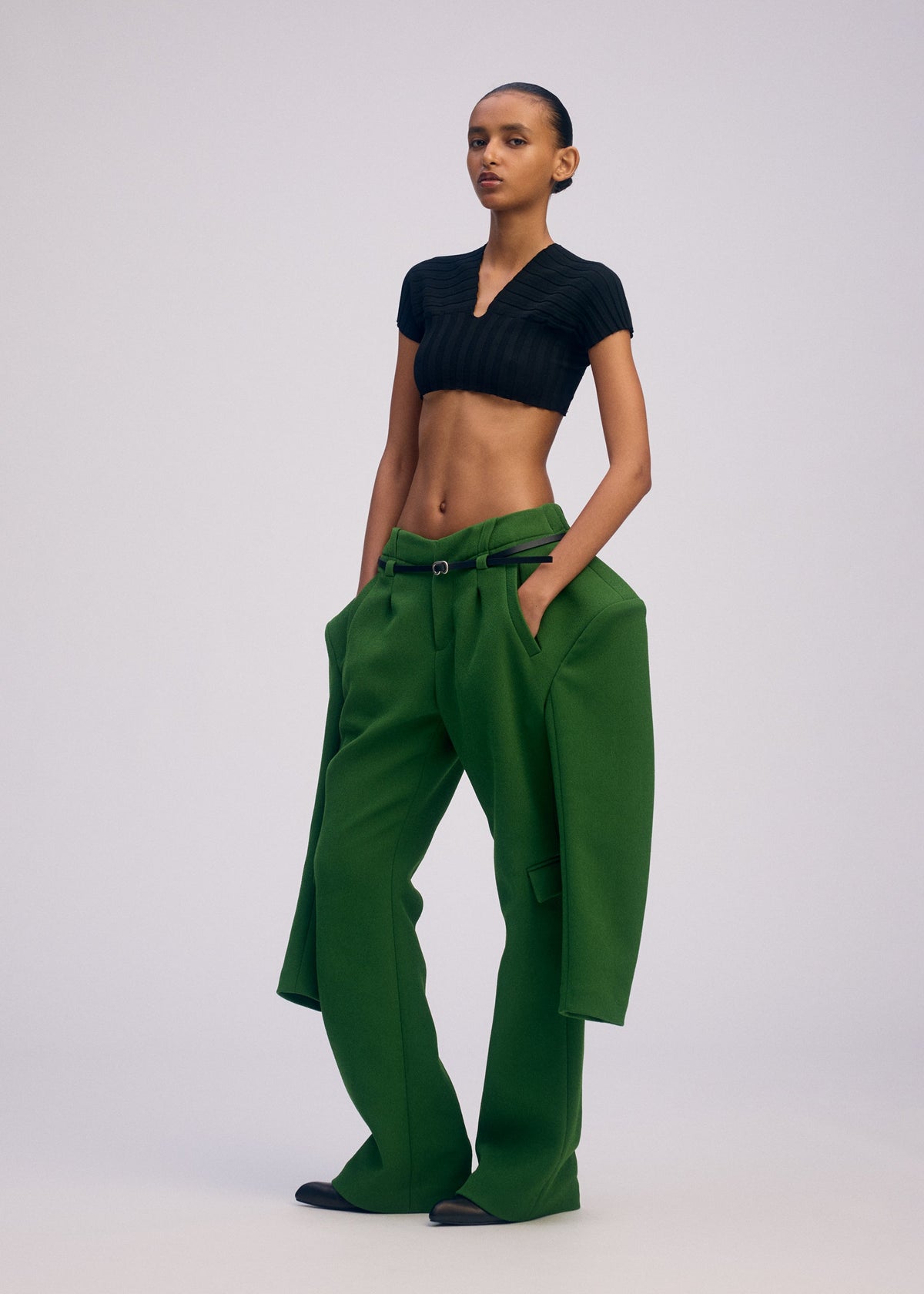 A model wears the ISSEY MIYAKE ARMS clothing.