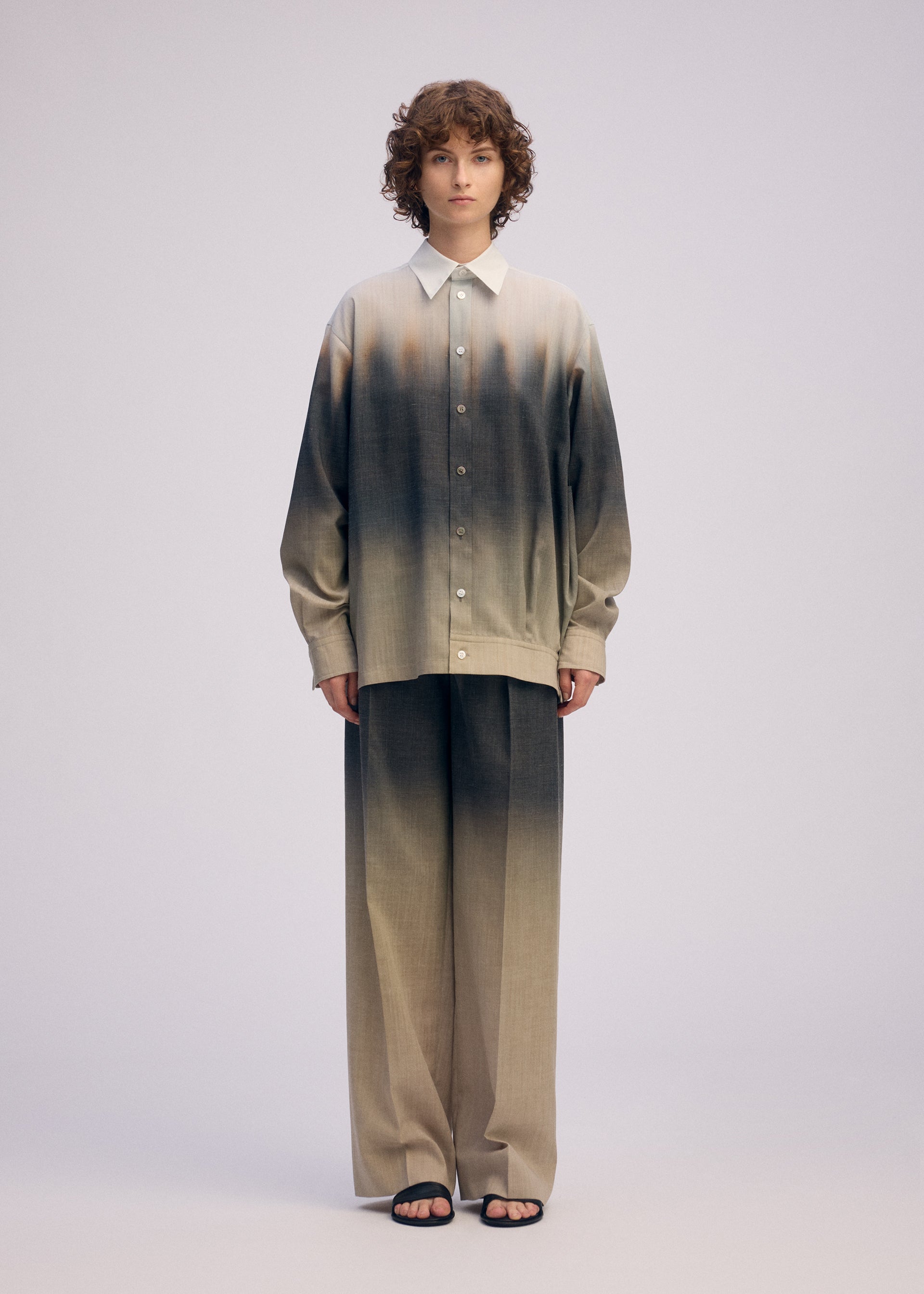 A model wears the ISSEY MIYAKE PLUMAGE plumage-trousers-chukar.