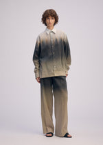 A model wears the ISSEY MIYAKE PLUMAGE plumage-trousers-starling.