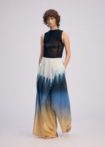 A model wears the ISSEY MIYAKE PLUMAGE plumage-trousers-chukar-1.