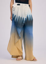 A model wears the ISSEY MIYAKE PLUMAGE plumage-trousers-starling-1.