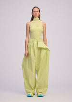 A model wears the ISSEY MIYAKE AKIMBO clothing.