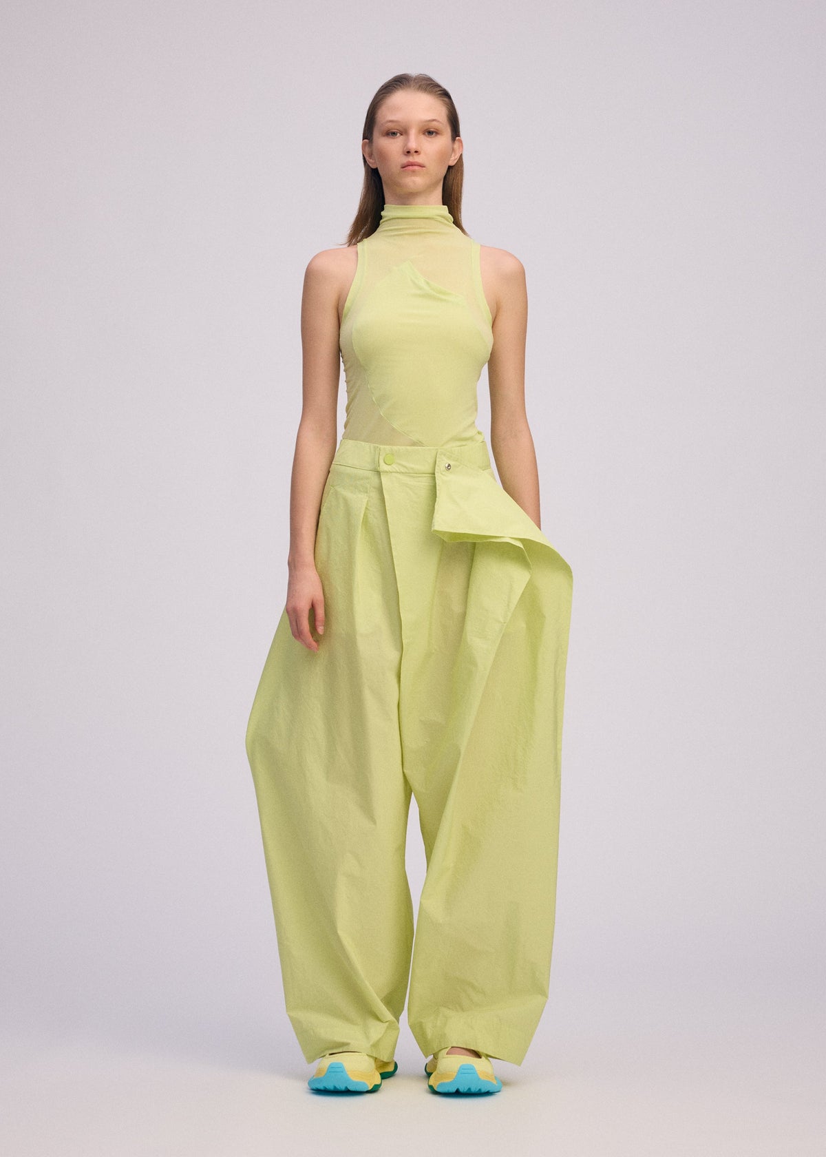 A model wears the ISSEY MIYAKE AKIMBO clothing.