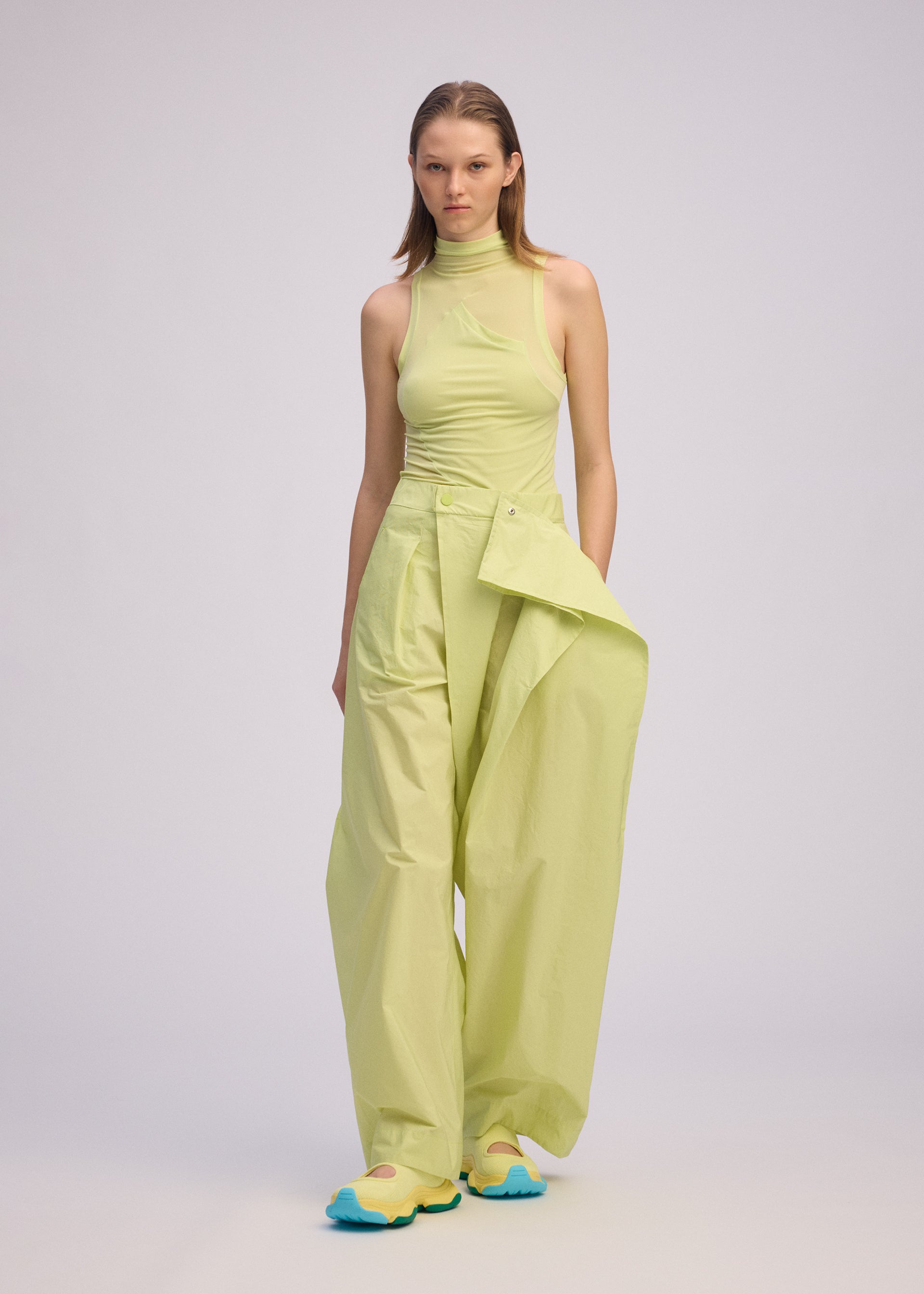 A model wears the ISSEY MIYAKE AKIMBO clothing.