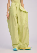 A model wears the ISSEY MIYAKE AKIMBO clothing.