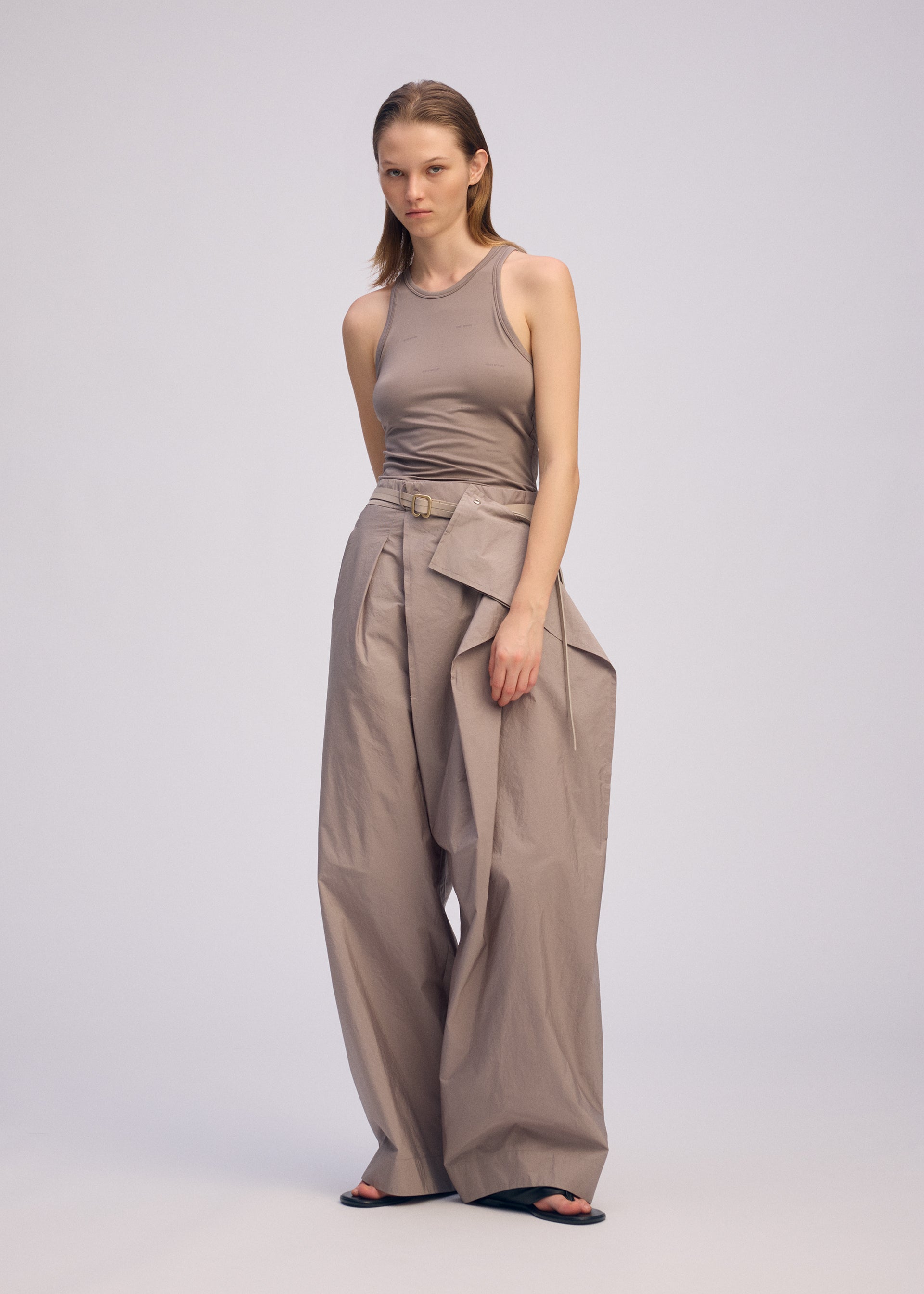 A model wears the ISSEY MIYAKE AKIMBO clothing.