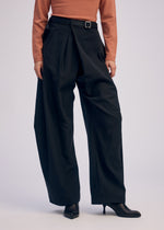 A model wears the ISSEY MIYAKE FLUTTERING PANTS trousers.