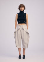 A model wears the ISSEY MIYAKE FLUTTERING PANTS trousers.