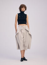 A model wears the ISSEY MIYAKE FLUTTERING PANTS trousers.