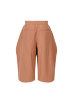 A detail shot of the ISSEY MIYAKE FLUTTERING PANTS trousers.