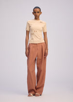 A model wears the ISSEY MIYAKE FLUTTERING PANTS trousers.