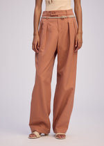A model wears the ISSEY MIYAKE FLUTTERING PANTS trousers.