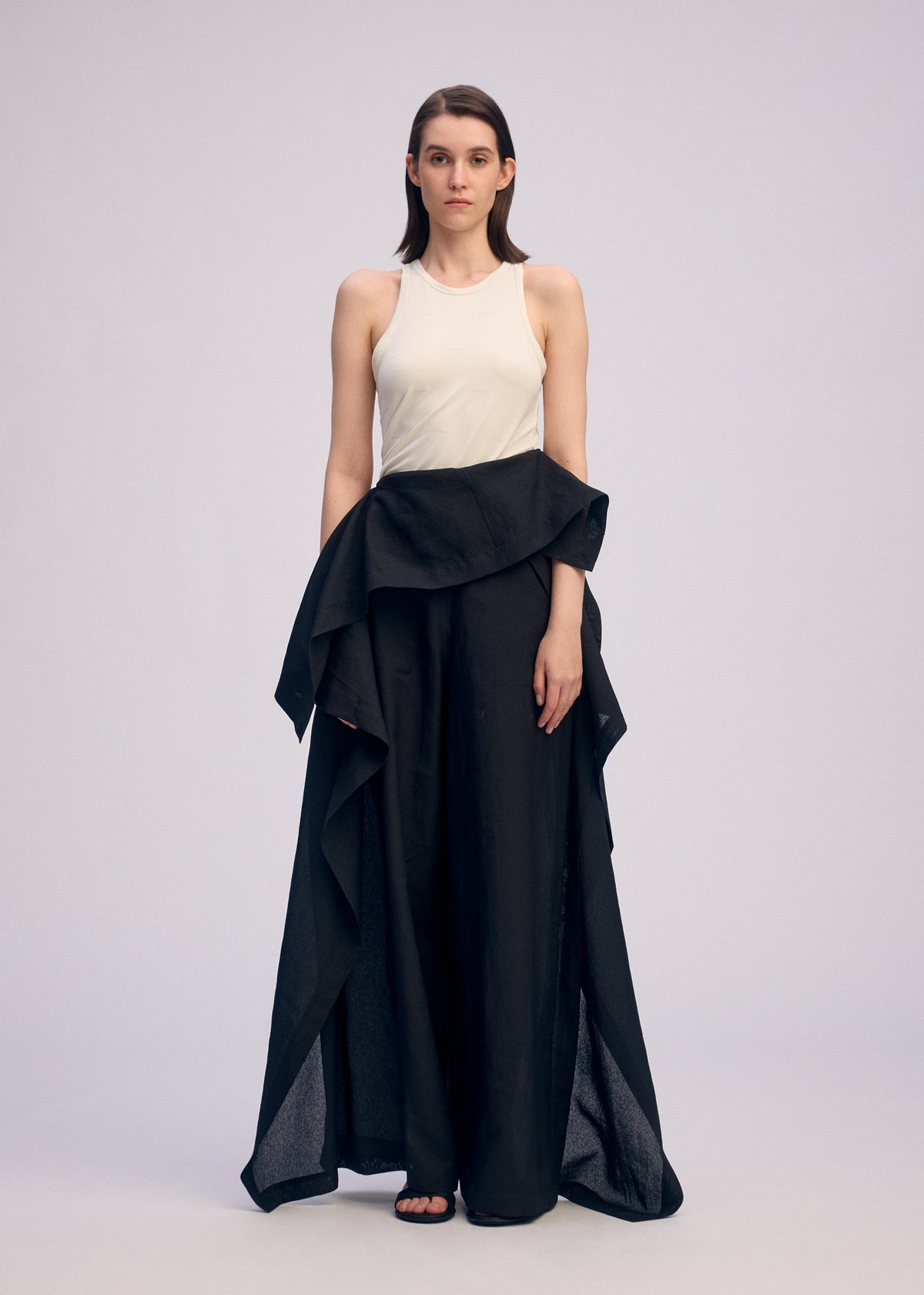 A model wears the ISSEY MIYAKE ALL SQUARES trousers.