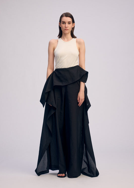A model wears the ISSEY MIYAKE ALL SQUARES trousers.