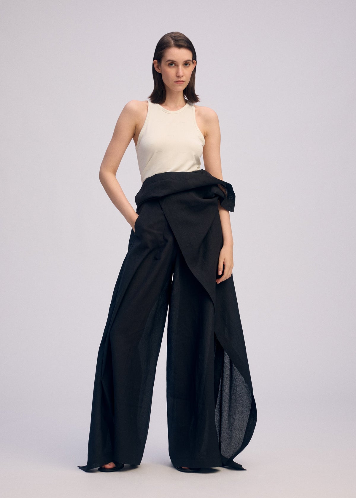 A model wears the ISSEY MIYAKE ALL SQUARES trousers.