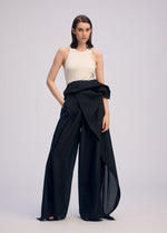 A model wears the ISSEY MIYAKE ALL SQUARES trousers.