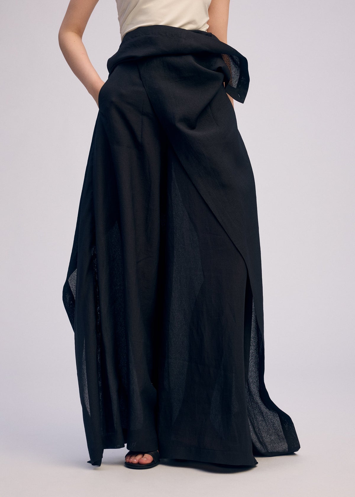 A model wears the ISSEY MIYAKE ALL SQUARES trousers.