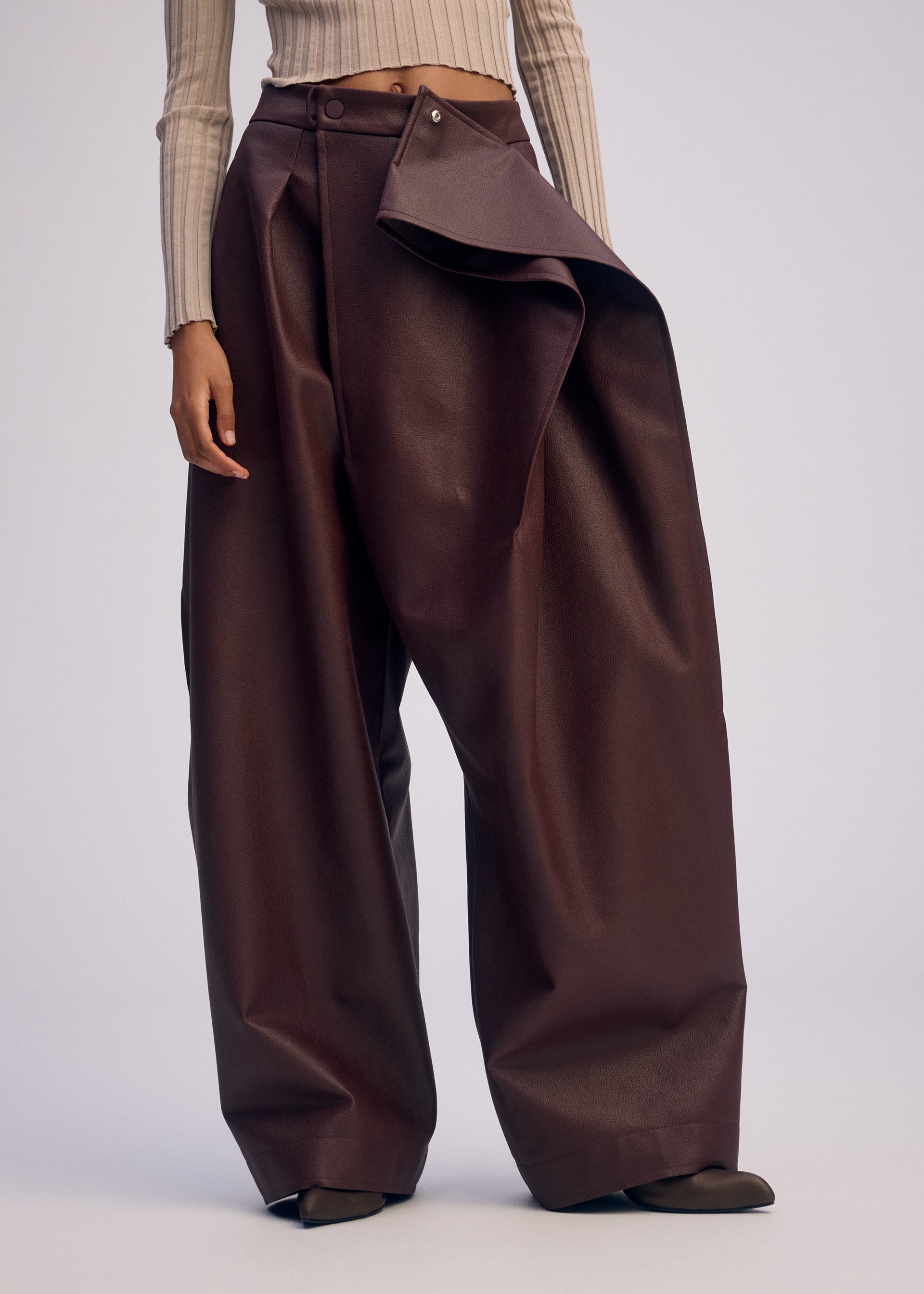 A model wears the ISSEY MIYAKE PRONOUNCED BODY clothing.