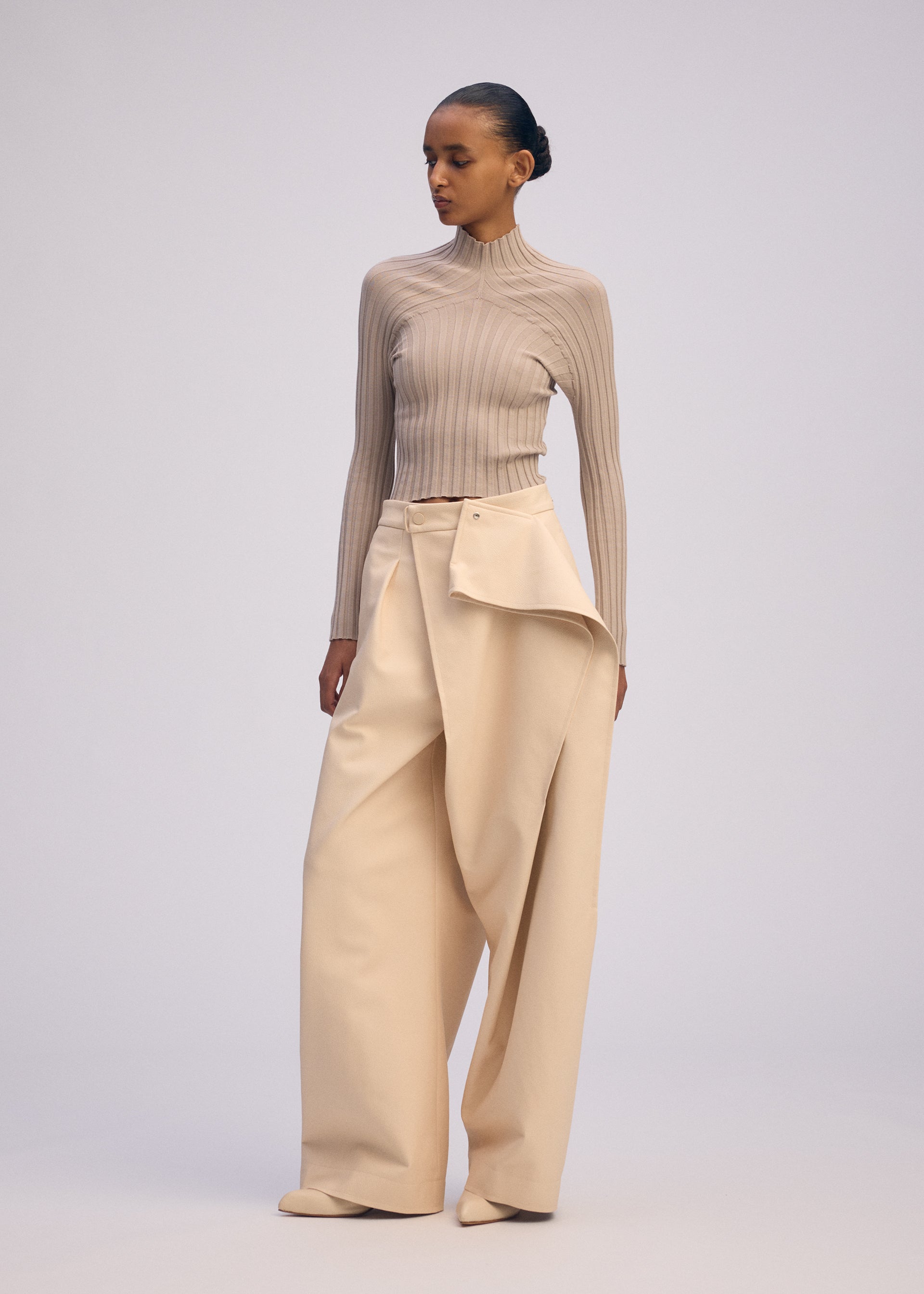 A model wears the ISSEY MIYAKE PRONOUNCED BODY clothing.