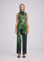 A model wears the ISSEY MIYAKE URBAN JUNGLE PLEATS trousers.