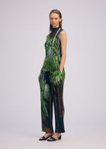 A model wears the ISSEY MIYAKE URBAN JUNGLE PLEATS trousers.