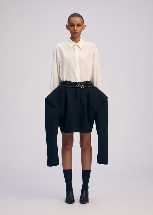 A model wears the ISSEY MIYAKE ARMS clothing.