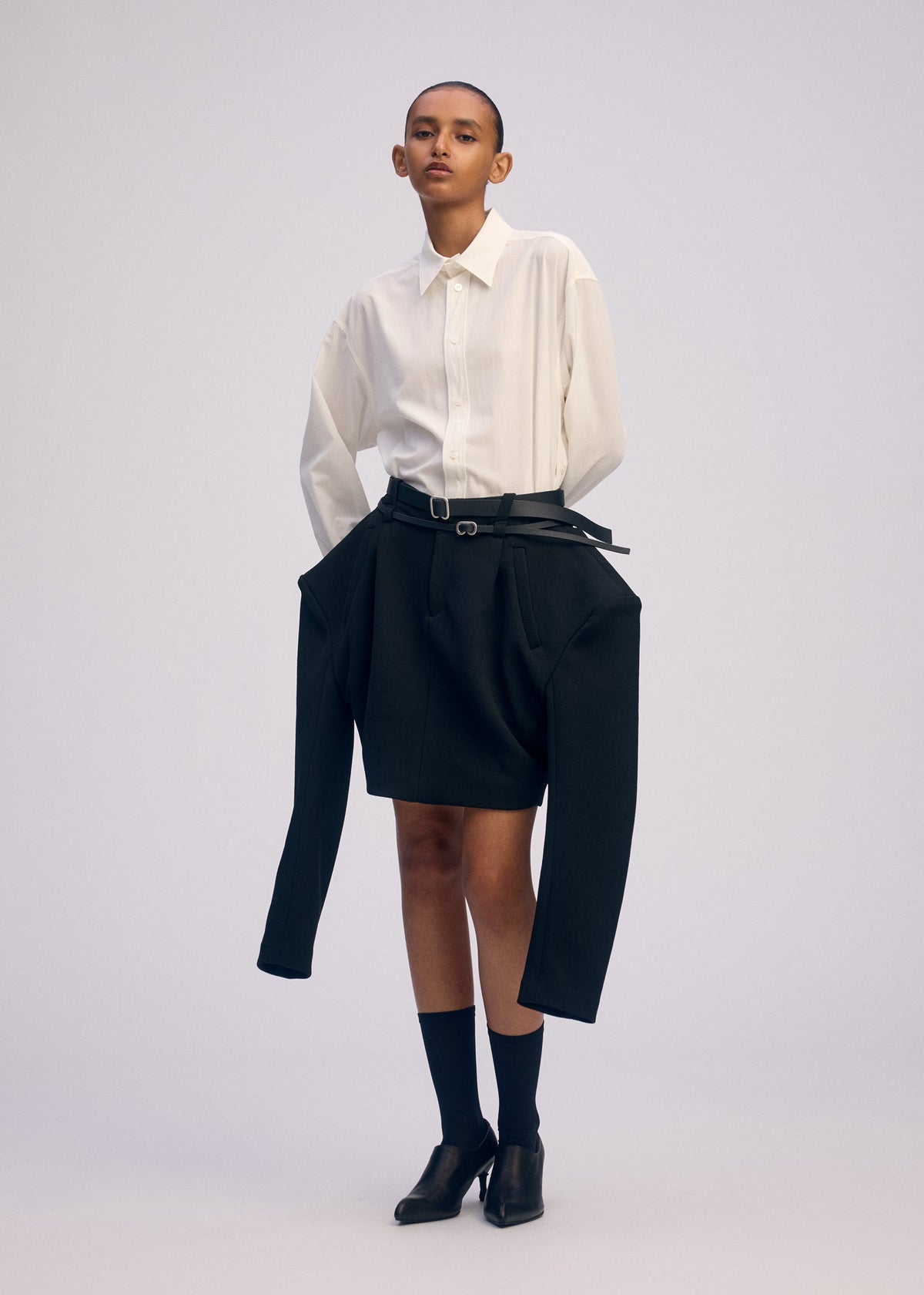 A model wears the ISSEY MIYAKE ARMS clothing.