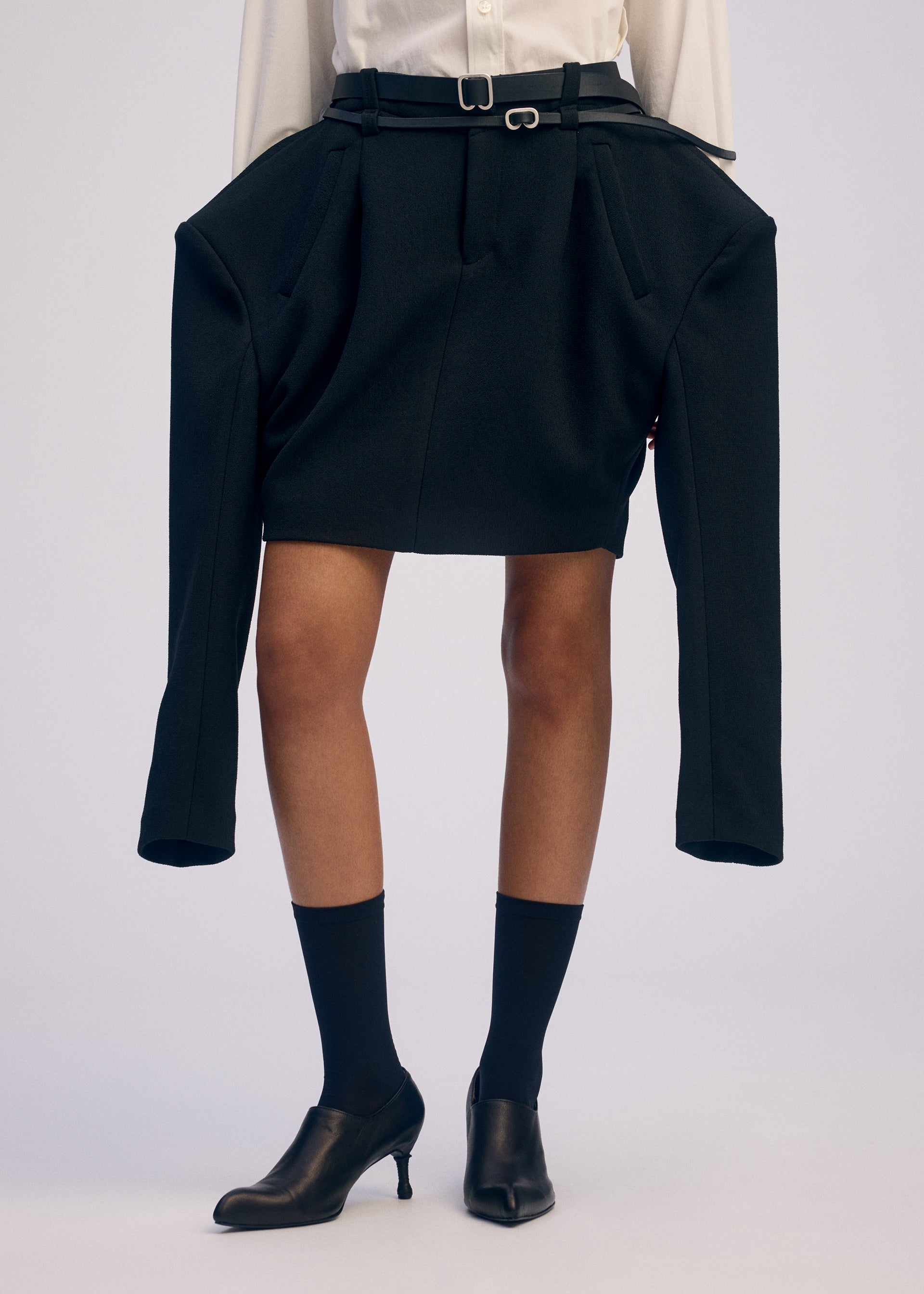A model wears the ISSEY MIYAKE ARMS clothing.