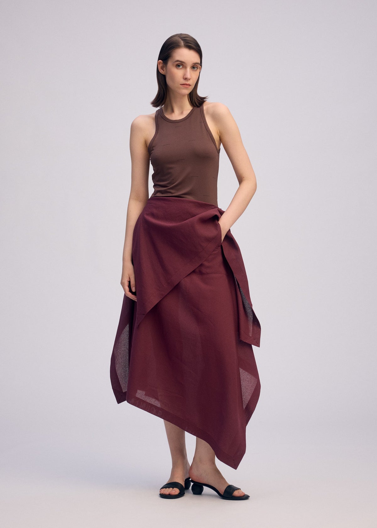 A model wears the ISSEY MIYAKE ALL SQUARES skirt.