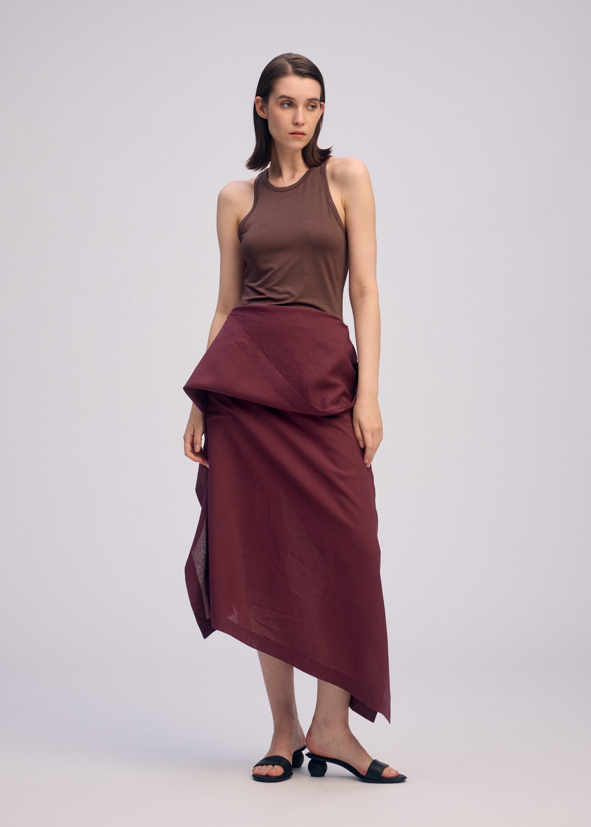 A model wears the ISSEY MIYAKE ALL SQUARES skirt.