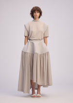 A model wears the ISSEY MIYAKE MUTE mute-skirt-light-grey.