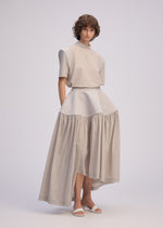 A model wears the ISSEY MIYAKE MUTE mute-skirt-light-grey.