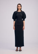 A model wears the ISSEY MIYAKE SLEEK PLEATS sleek-pleats-skirt-burgundy.