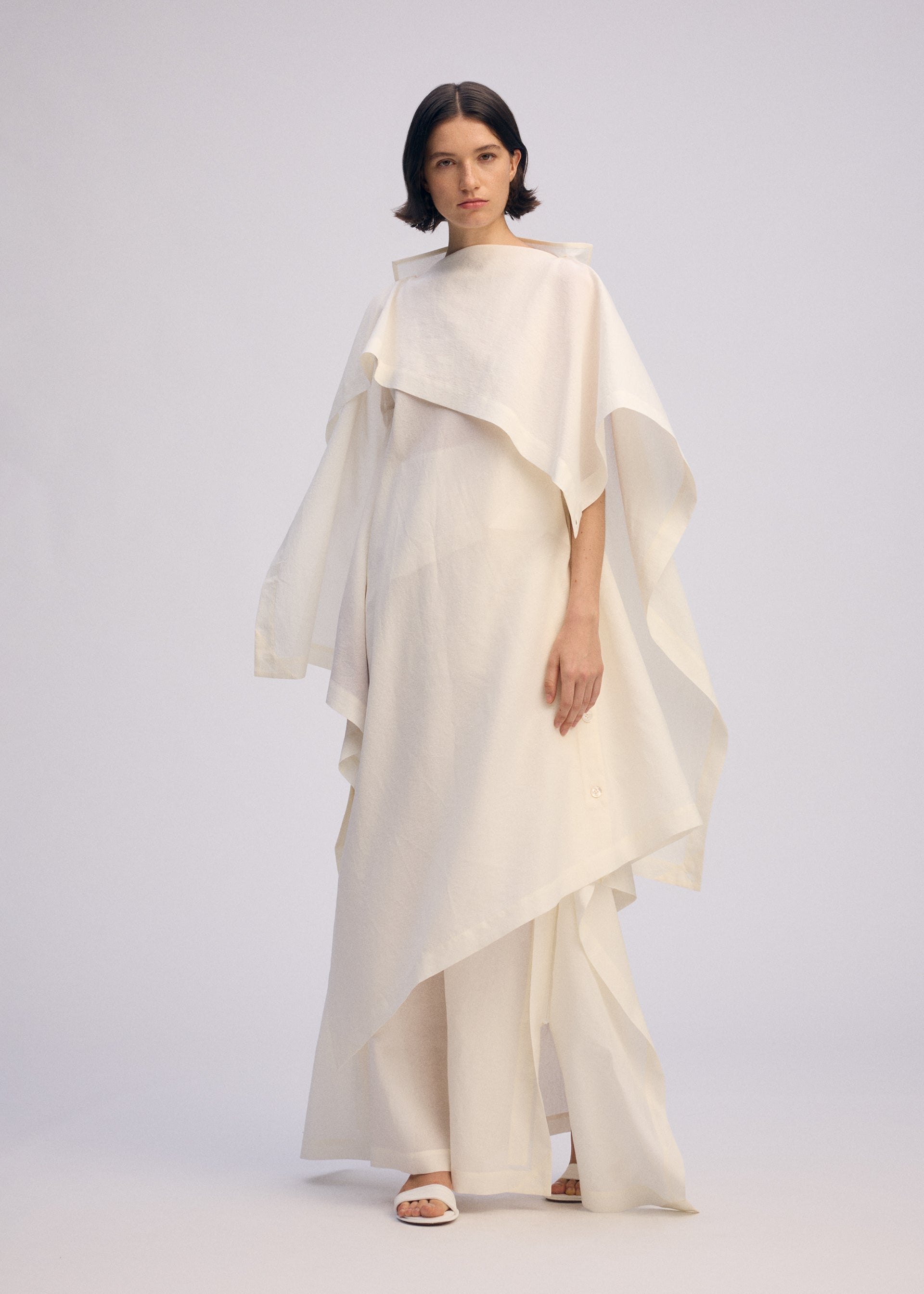 A model wears the ISSEY MIYAKE ALL SQUARES dress.