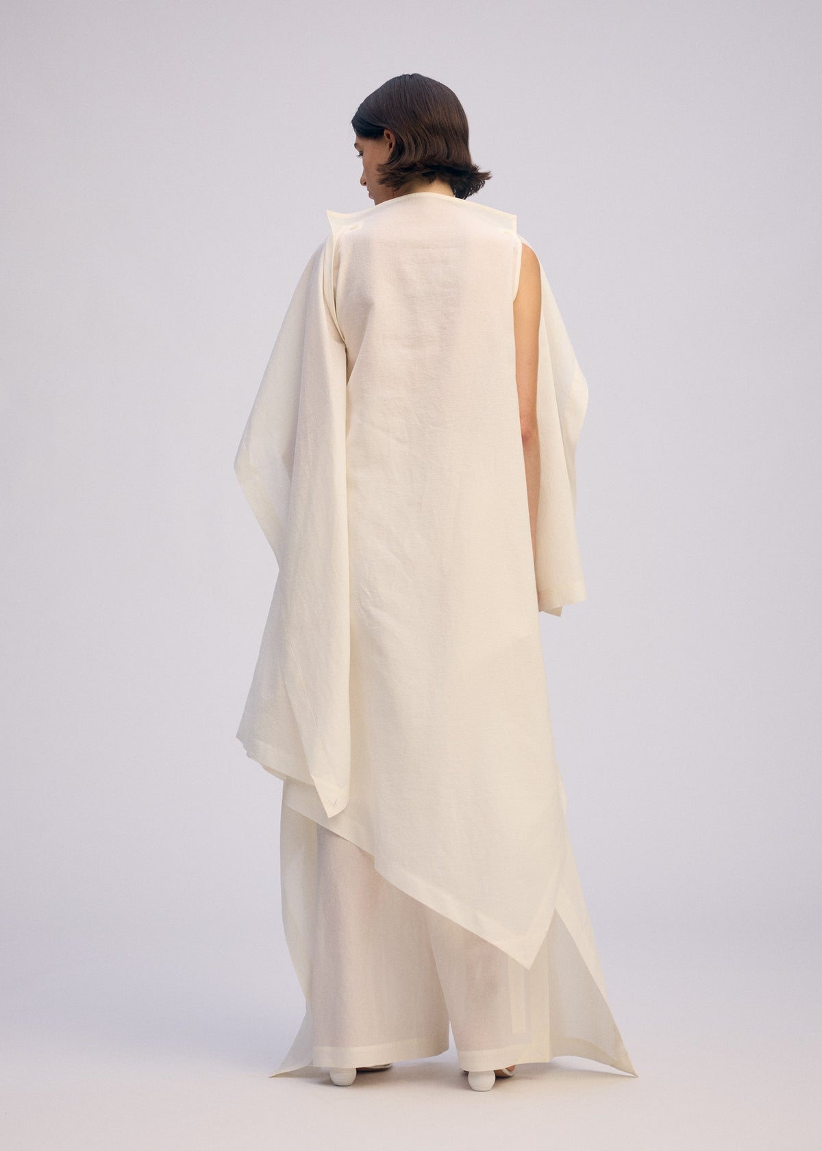 A model wears the ISSEY MIYAKE ALL SQUARES dress.